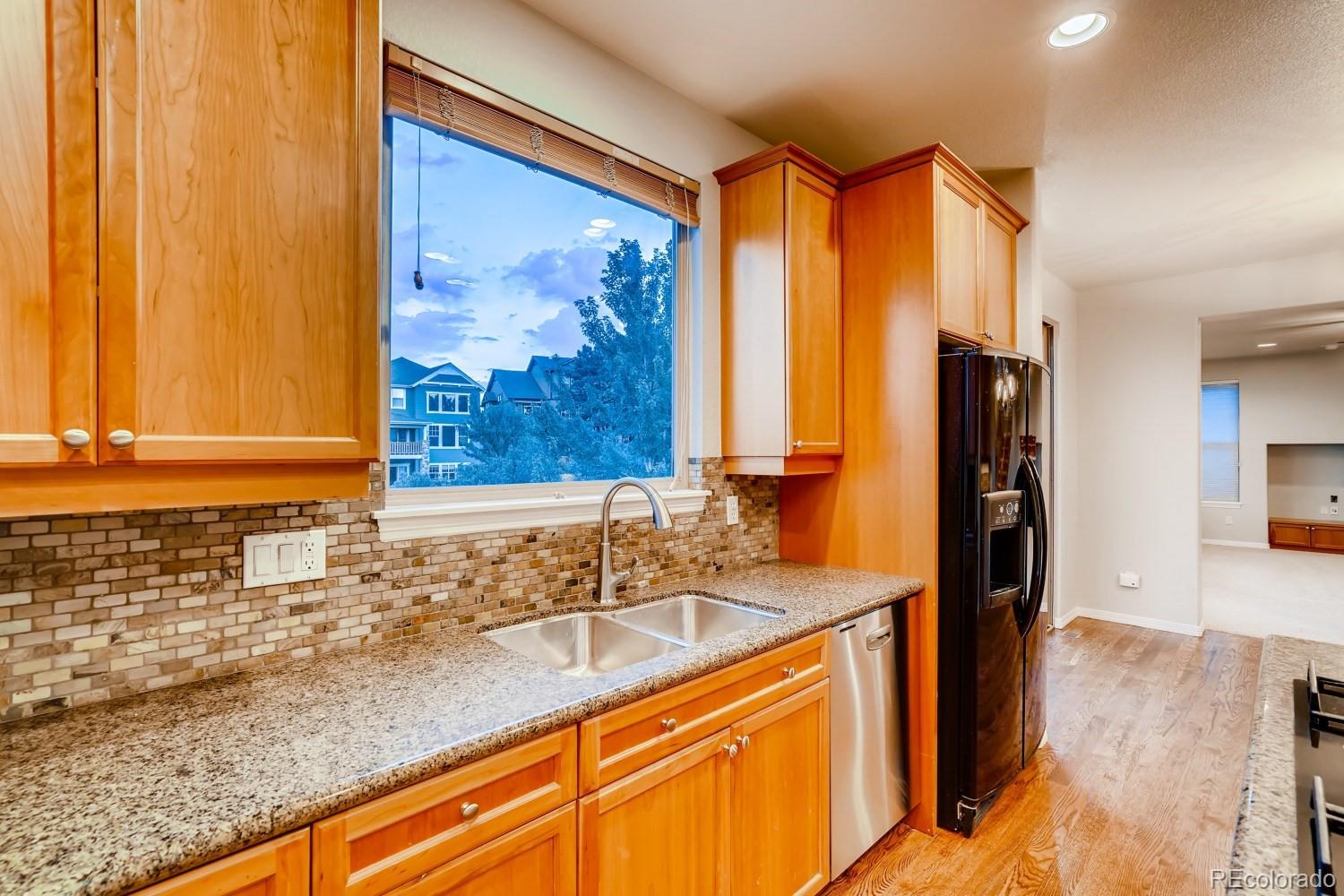 1644 Ridge Trail Lane Castle Rock, CO 80104 - Photo 9 of 38 a kitchen with a sink cabinets and a large window
