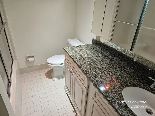 a bathroom with a shower toilet and sink