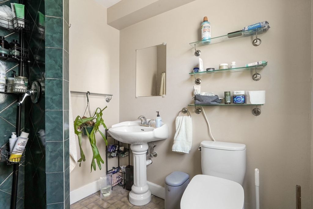 33-35 Russell Street, Unit 1 Brookline, MA 02446 - Photo 11 of 16 a bathroom with a sink toilet and mirror