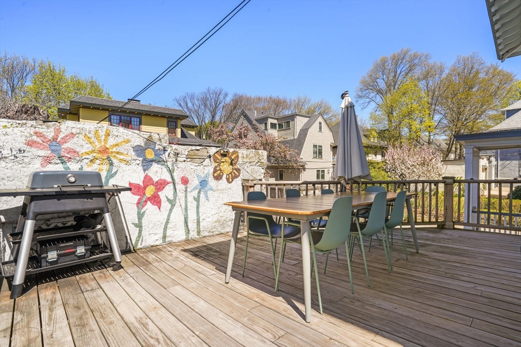 33-35 Russell Street, Unit 1 Brookline, MA 02446 - Photo 14 of 16 a view of a house with wooden deck and furniture