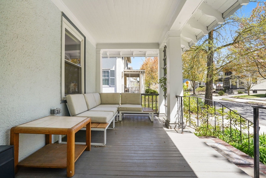33-35 Russell Street, Unit 1 Brookline, MA 02446 - Photo 2 of 16 a balcony with wooden floor table and chairs