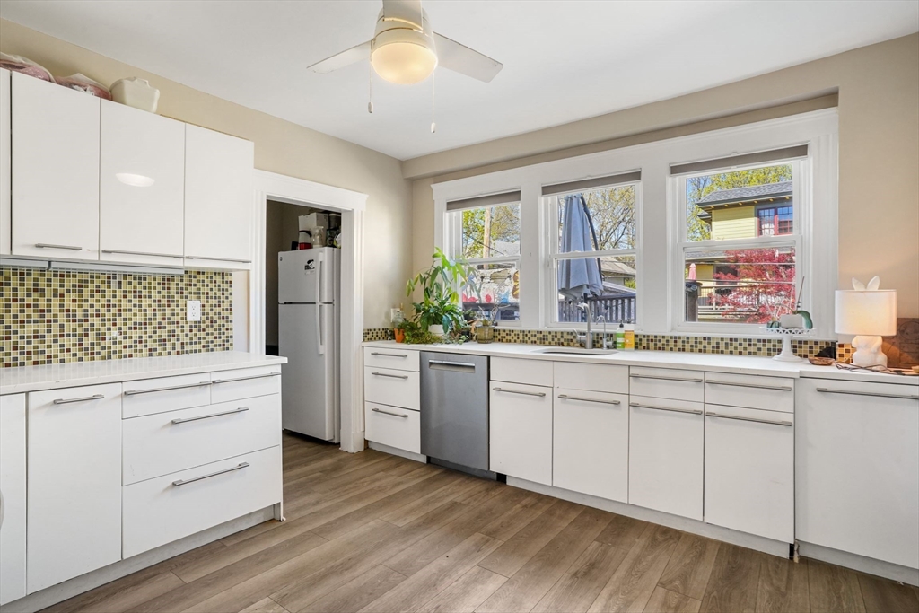 33-35 Russell Street, Unit 1 Brookline, MA 02446 - Photo 3 of 16 a kitchen with white cabinets and sink