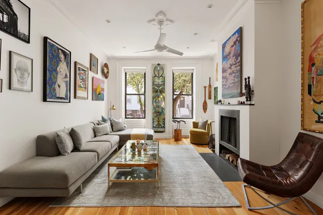 a living room with furniture a fireplace and a chandelier