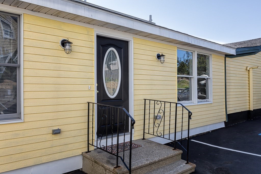 2 Farragut Road, Unit 5 Ipswich, MA 01938 - Photo 1 of 15 a front view of a house with a wooden fence