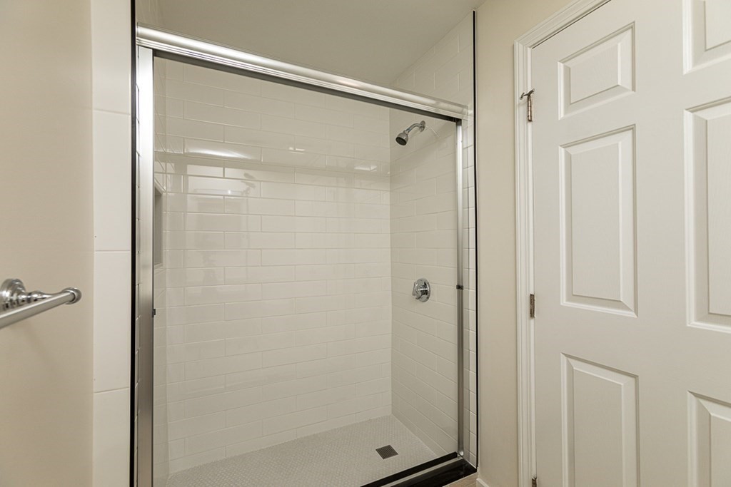 2 Farragut Road, Unit 5 Ipswich, MA 01938 - Photo 12 of 15 a bathroom with a glass shower door