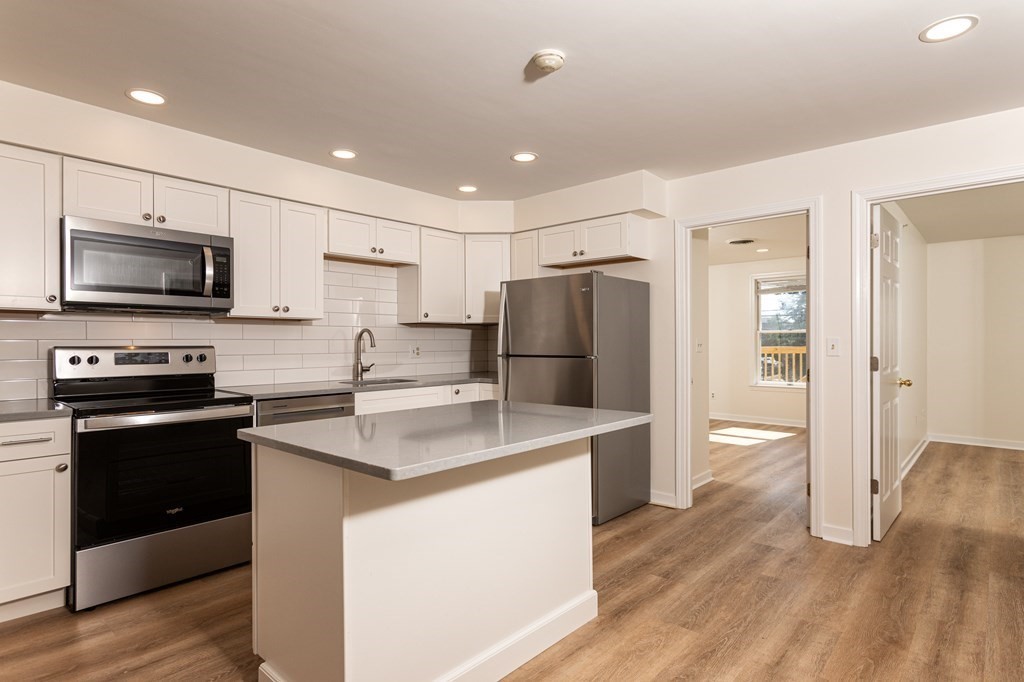 2 Farragut Road, Unit 5 Ipswich, MA 01938 - Photo 2 of 15 a kitchen with appliances a sink and a refrigerator