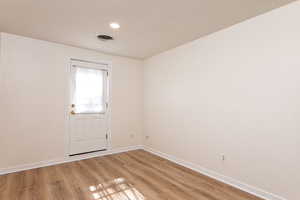 2 Farragut Road, Unit 5 Ipswich, MA 01938 - Photo 8 of 15 a view of a room with wooden floor and white walls