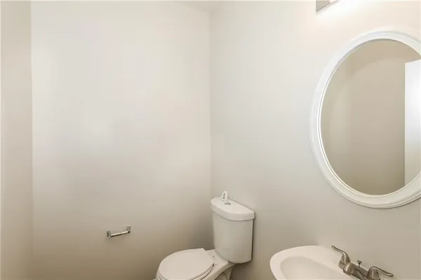 a white toilet sitting next to a white sink