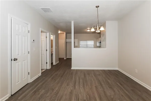 a view of a room with wooden floor and window