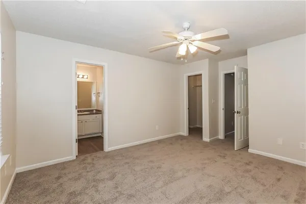 a view of an empty room with a ceiling fan