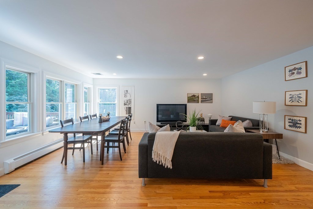 49 Baskin Road Lexington, MA 02421 - Photo 17 of 42 a living room with furniture a dining table and a wooden floor