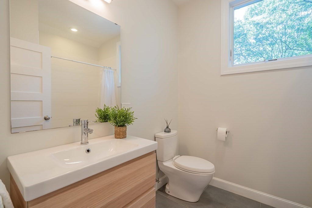 49 Baskin Road Lexington, MA 02421 - Photo 33 of 42 a bathroom with a sink a toilet and mirror