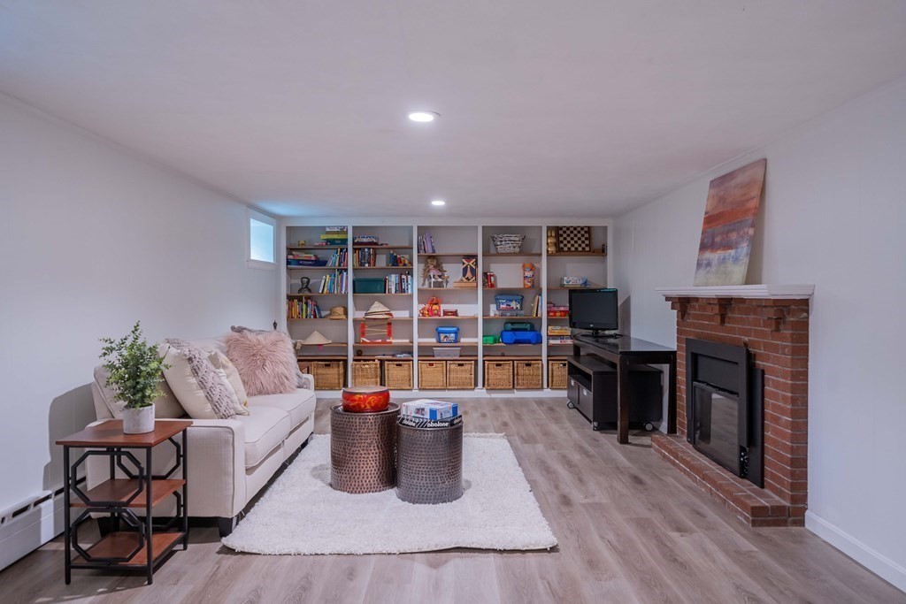 49 Baskin Road Lexington, MA 02421 - Photo 36 of 42 a living room with furniture and a fireplace