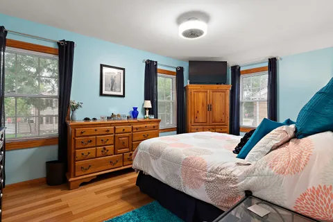 a bedroom with a bed and large window