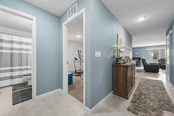 a living room with stainless steel appliances kitchen island granite countertop furniture a refrigerator a sink a stove top oven a dining table and chairs