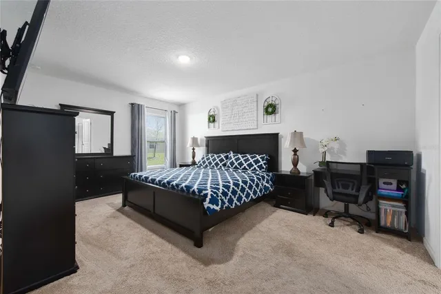 a bed sitting in a bedroom next to a window