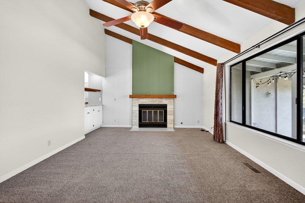 913 Ridgemark Drive Hollister, CA 95023 - Photo 18 of 75 a view of an empty room with a fireplace and a window