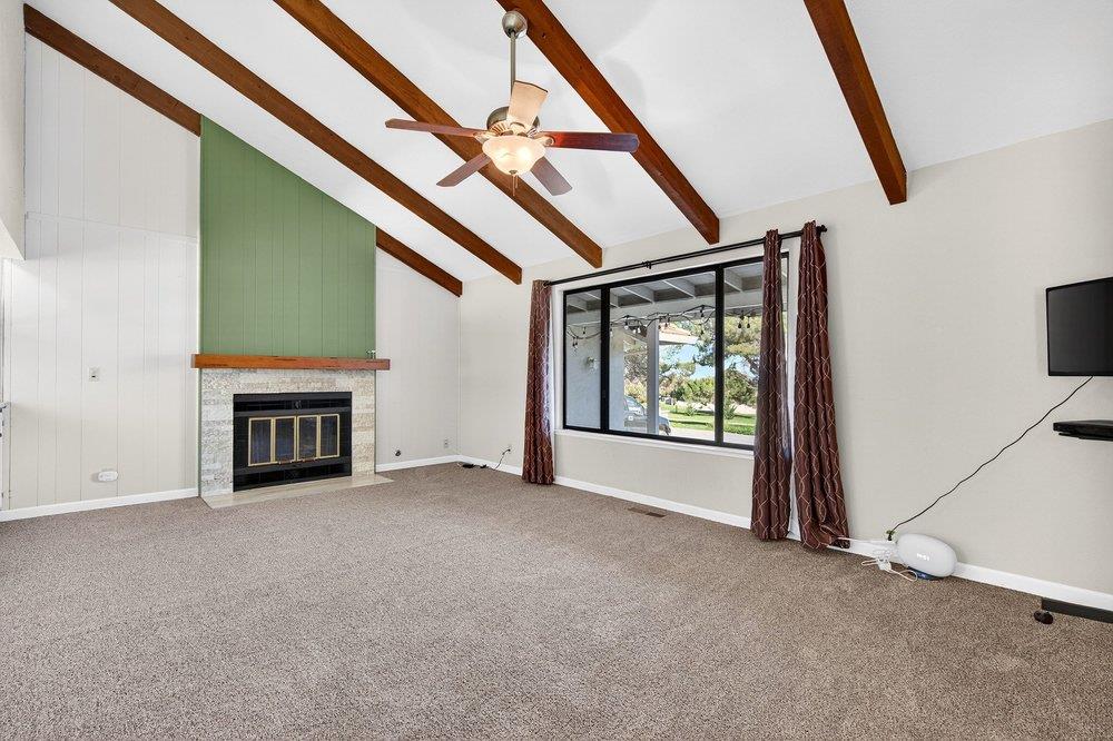 913 Ridgemark Drive Hollister, CA 95023 - Photo 19 of 75 a view of an empty room with a fireplace and a window