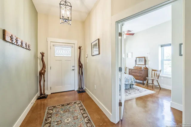 a view of a livingroom with wooden floor and furniture