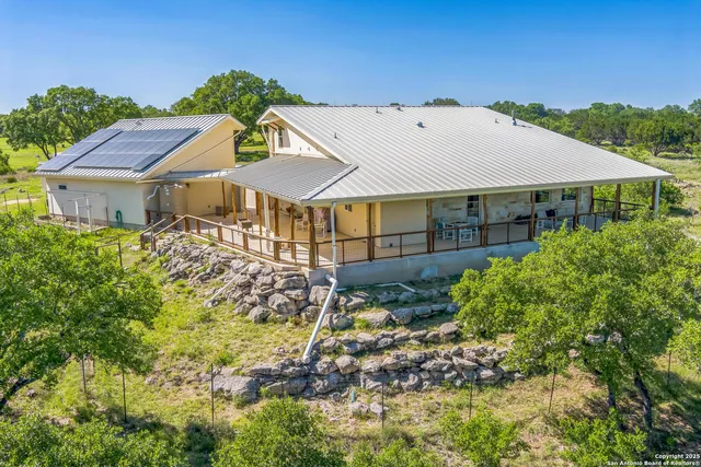 a aerial view of a house next to a yard