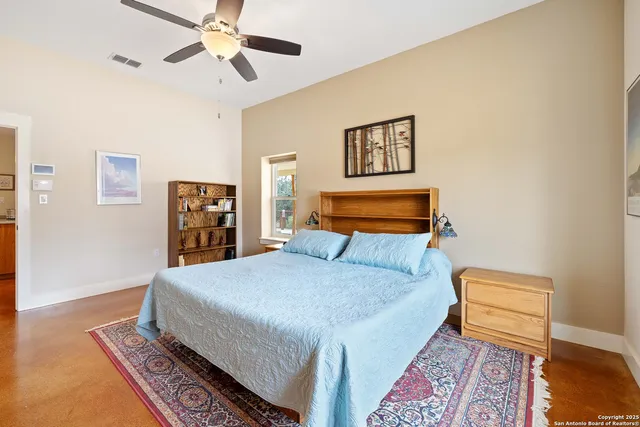 a bedroom with a bed and a rug