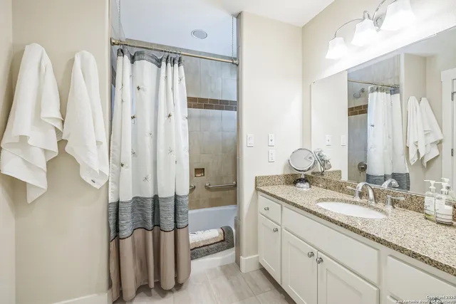 a bathroom with a double vanity sink and mirror