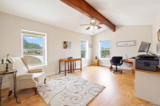 a living room with furniture window and a wooden floor