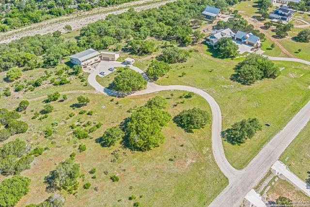 a view of residential houses with yard and mountain view