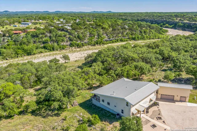 an aerial view of a house with big yard