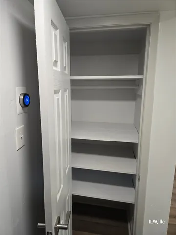 a view of walk in closet with empty racks