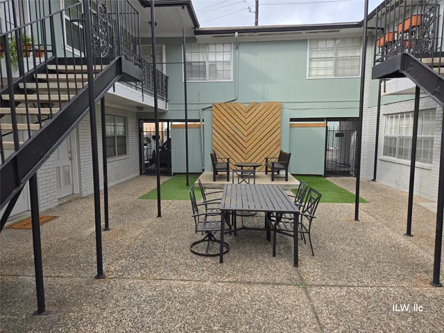 a view of a patio with a table and chairs