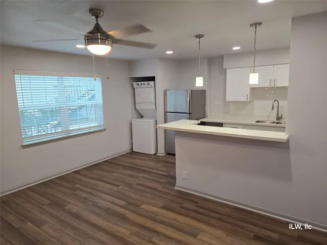 a view of kitchen with stainless steel appliances granite countertop cabinets and wooden floor