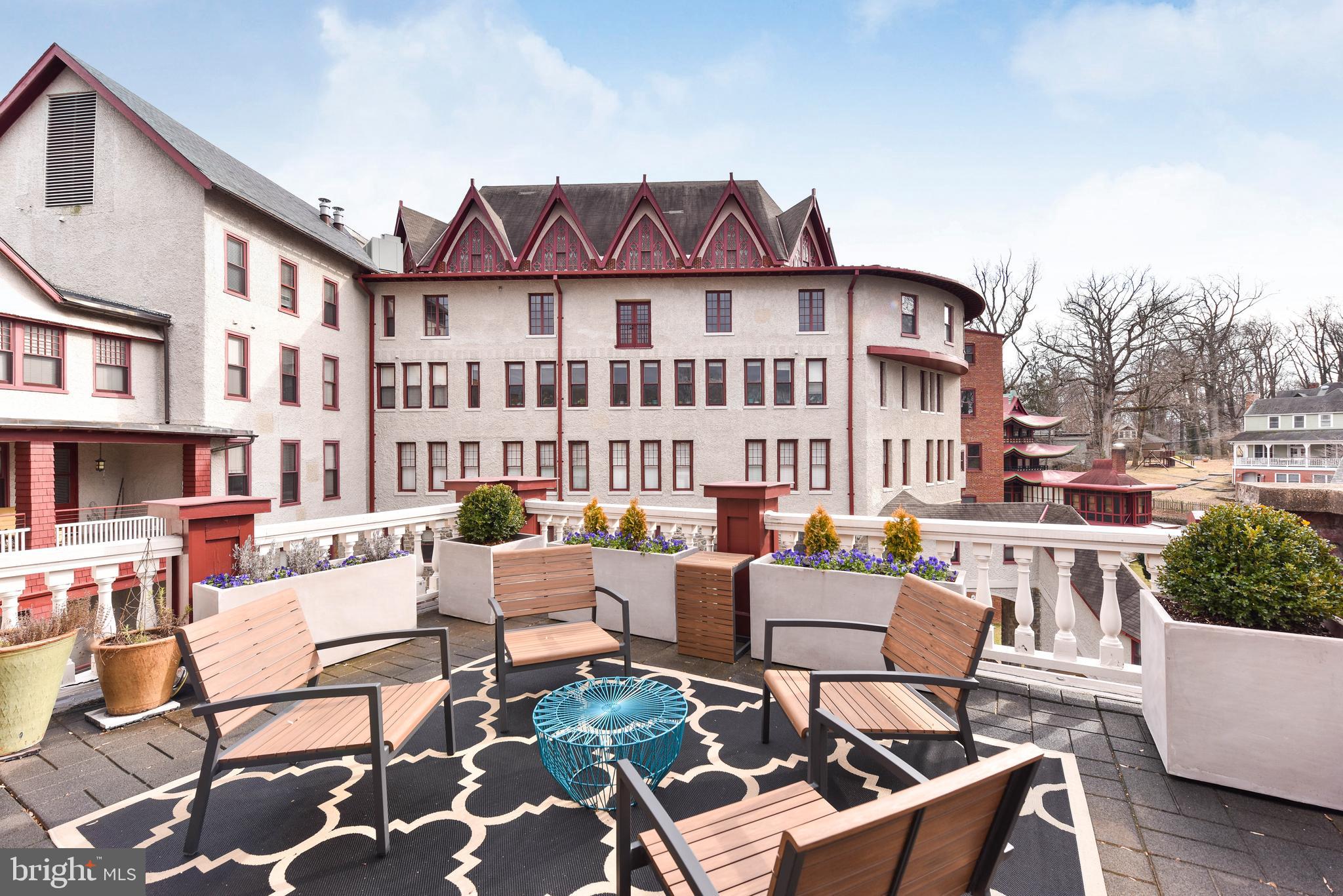 2829 Sacks Street, Unit SA506 Silver Spring, MD 20910 - Photo 11 of 34 a view of a patio with couches table and chairs and potted plants