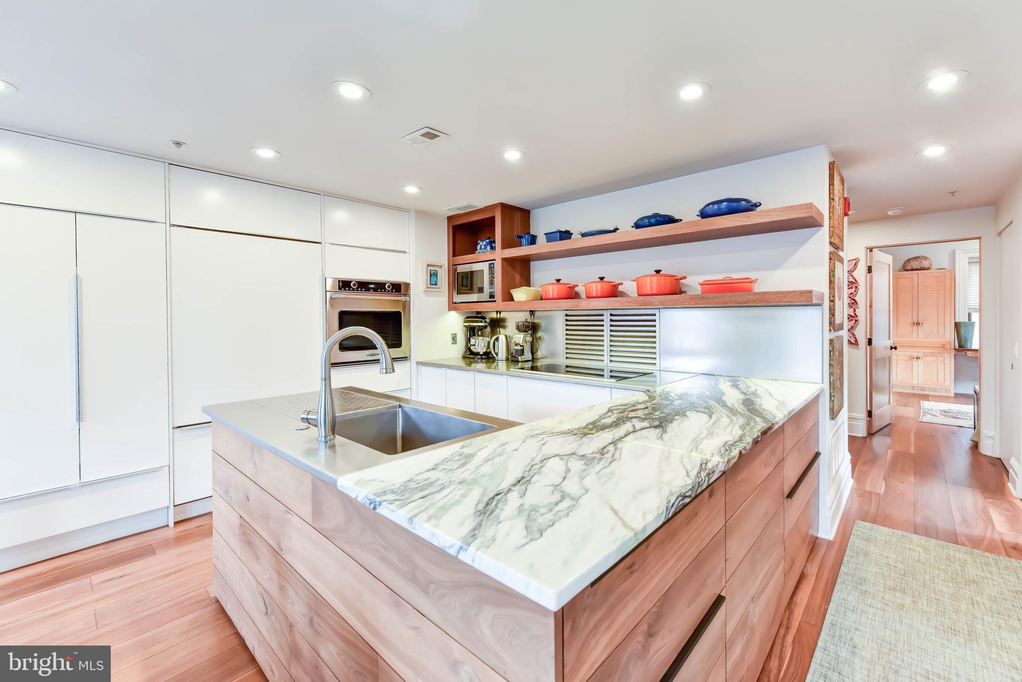2829 Sacks Street, Unit SA506 Silver Spring, MD 20910 - Photo 5 of 34 a kitchen with stainless steel appliances granite countertop a sink and a wooden floors