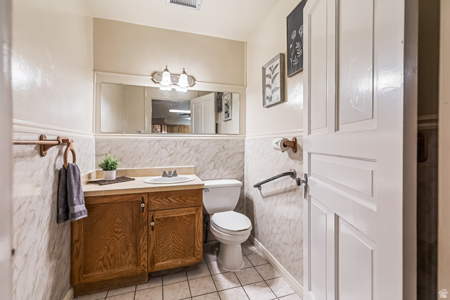 21 North Main Street Kingston, UT 84743 - Photo 72 of 107 Half bath featuring vanity, light tile patterned flooring, tile walls, and a wainscoted wall