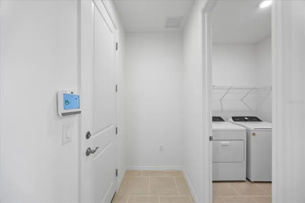 a kitchen with kitchen island white cabinets and stainless steel appliances