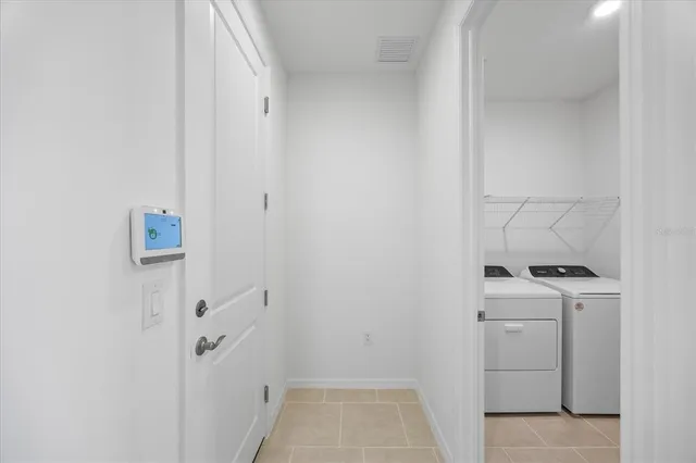 a kitchen with kitchen island white cabinets and stainless steel appliances