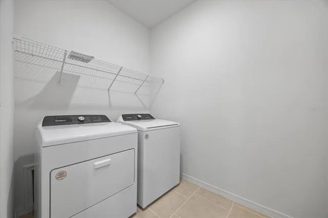a kitchen with stainless steel appliances a refrigerator stove and white cabinets