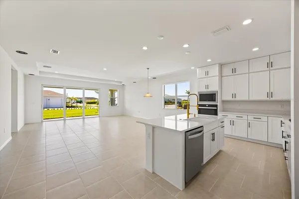 a kitchen with stainless steel appliances a refrigerator sink and stove