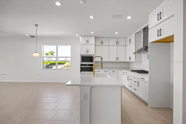 a kitchen with a stove cabinets and a stove top oven