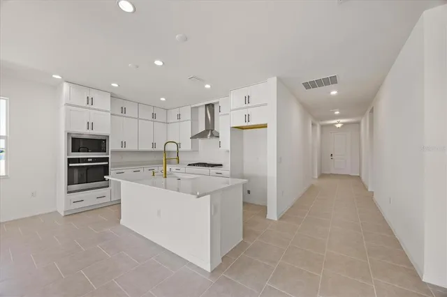 a kitchen with granite countertop a sink stove and cabinets