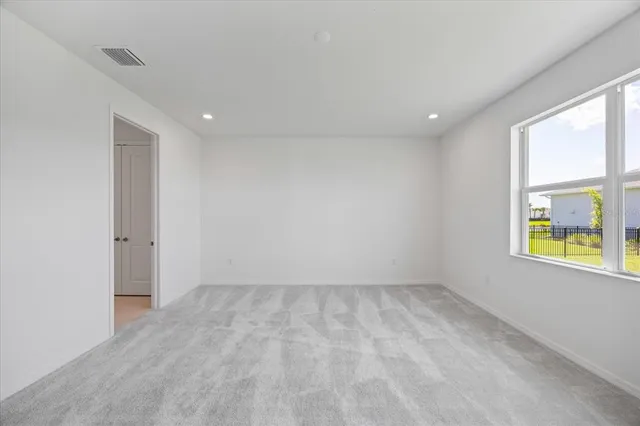 a view of a house with a yard and potted plants