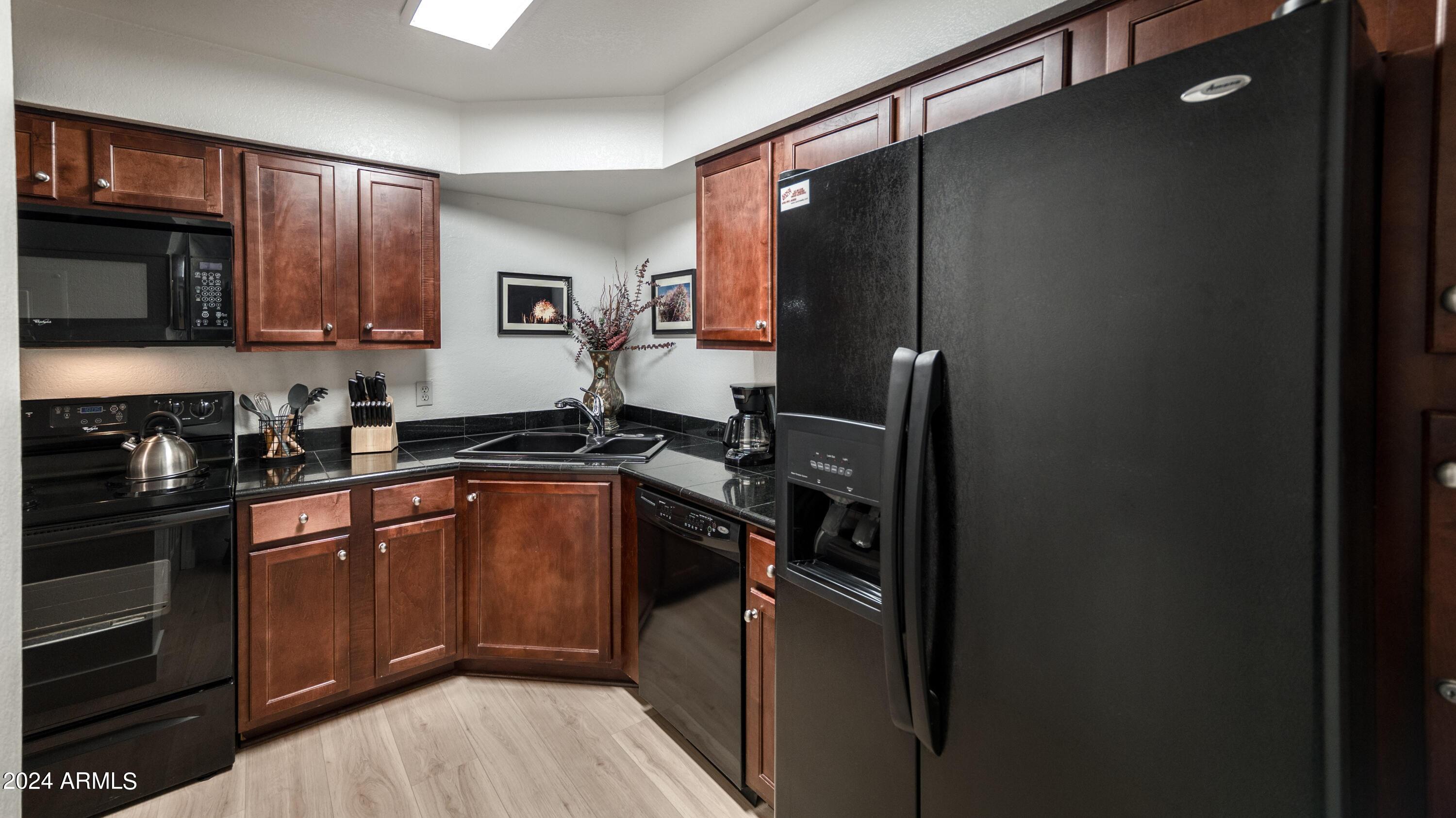 8787 East Mountain View Road, Unit 1034 Scottsdale, AZ 85258 - Photo 11 of 43 a kitchen with a sink stove and refrigerator