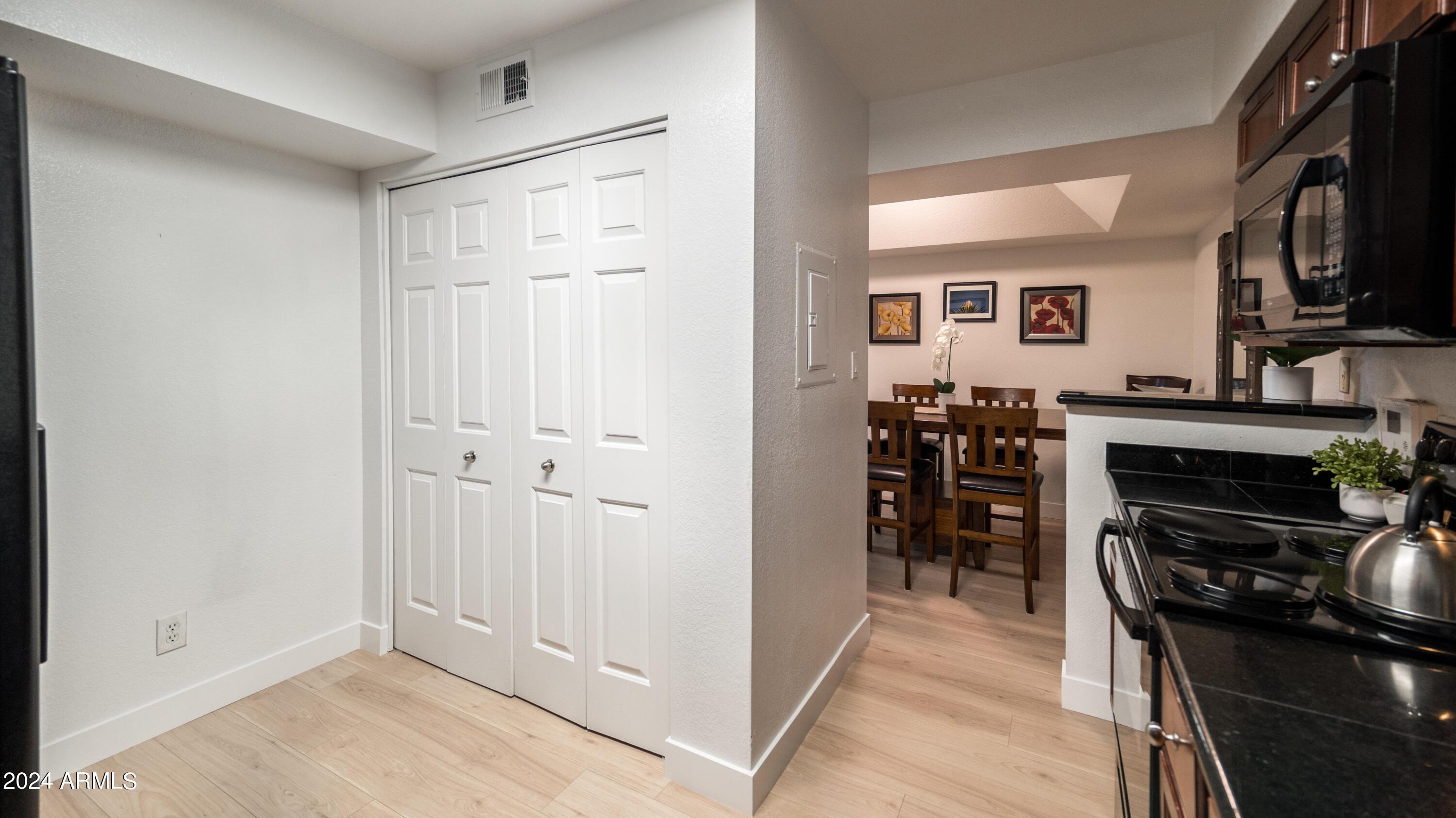 8787 East Mountain View Road, Unit 1034 Scottsdale, AZ 85258 - Photo 12 of 43 a view of a kitchen with furniture and an empty room