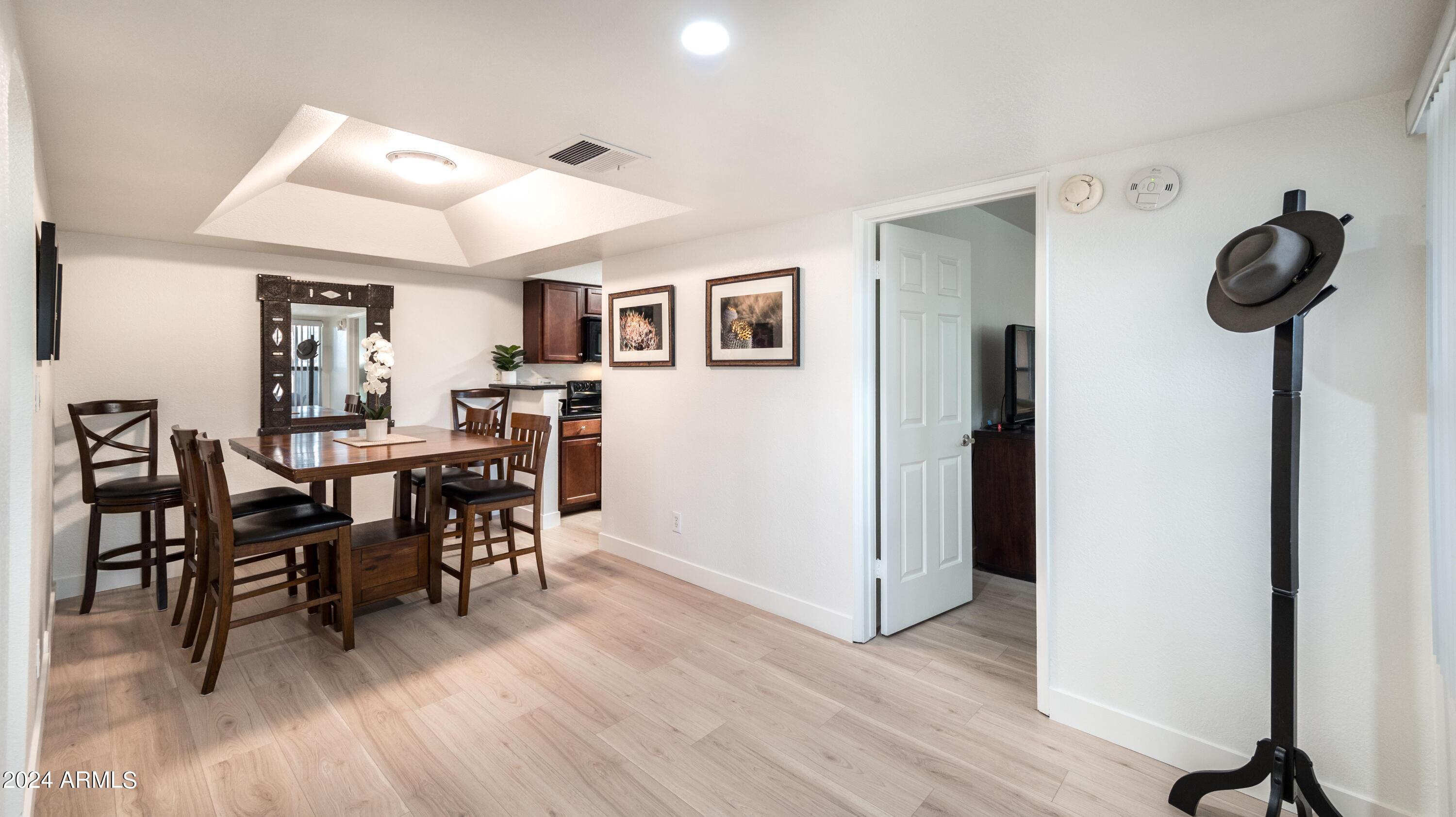 8787 East Mountain View Road, Unit 1034 Scottsdale, AZ 85258 - Photo 17 of 43 a view of a dining room with furniture and wooden floor