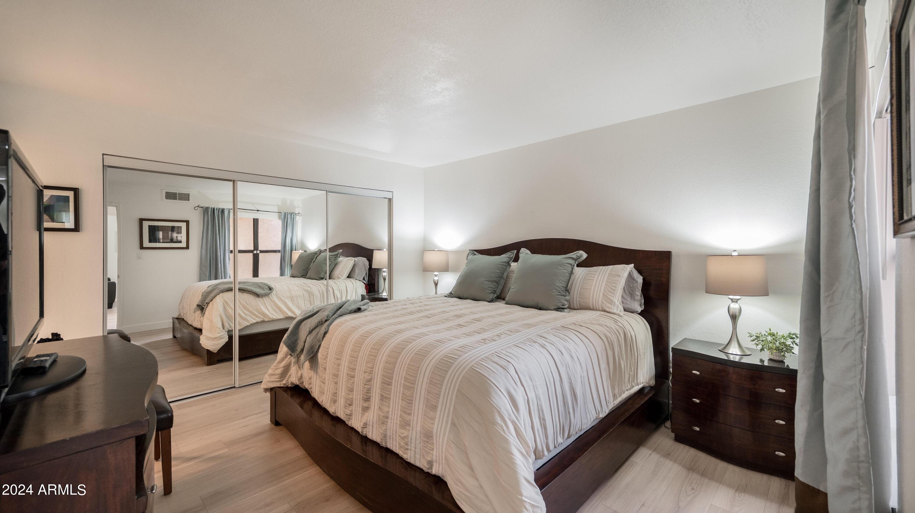 8787 East Mountain View Road, Unit 1034 Scottsdale, AZ 85258 - Photo 19 of 43 a bedroom with two beds and a night stand