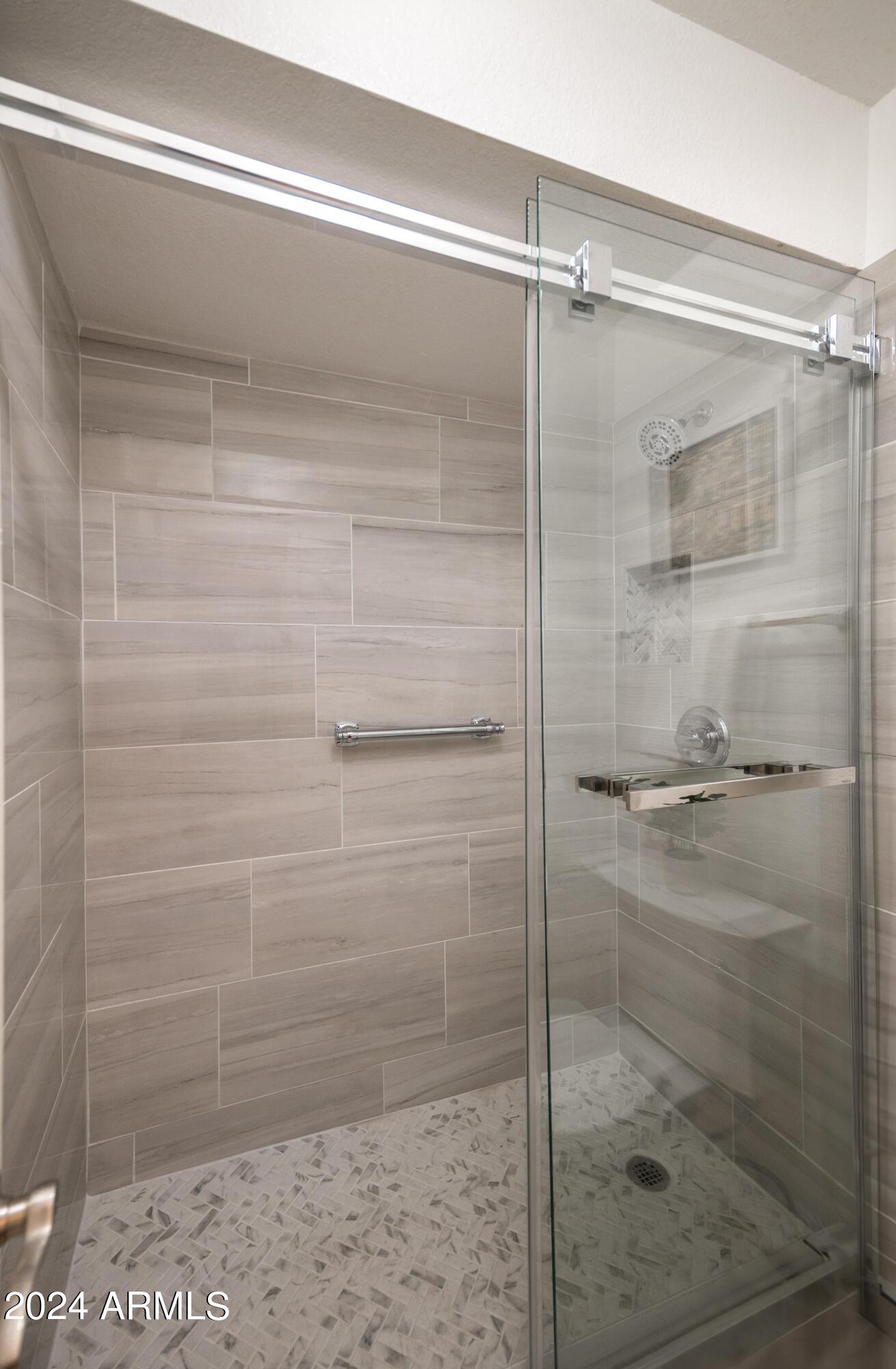 8787 East Mountain View Road, Unit 1034 Scottsdale, AZ 85258 - Photo 23 of 43 a bathroom with a glass shower door