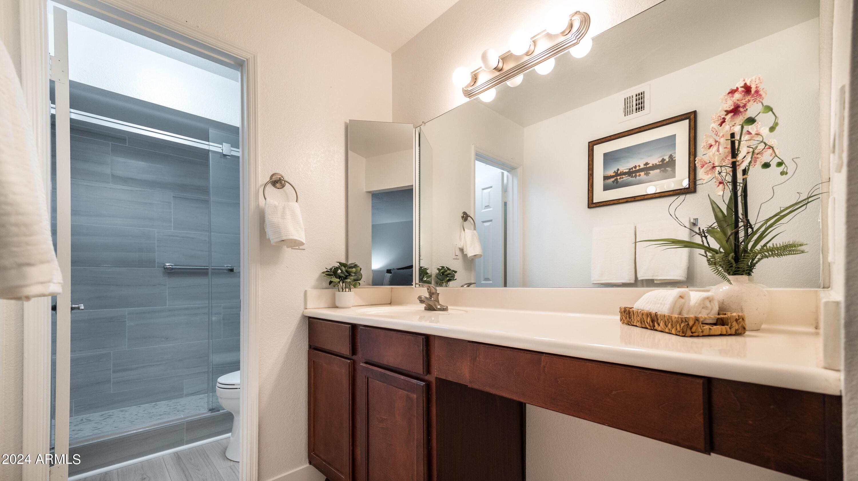8787 East Mountain View Road, Unit 1034 Scottsdale, AZ 85258 - Photo 24 of 43 a bathroom with a sink a vanity and a mirror