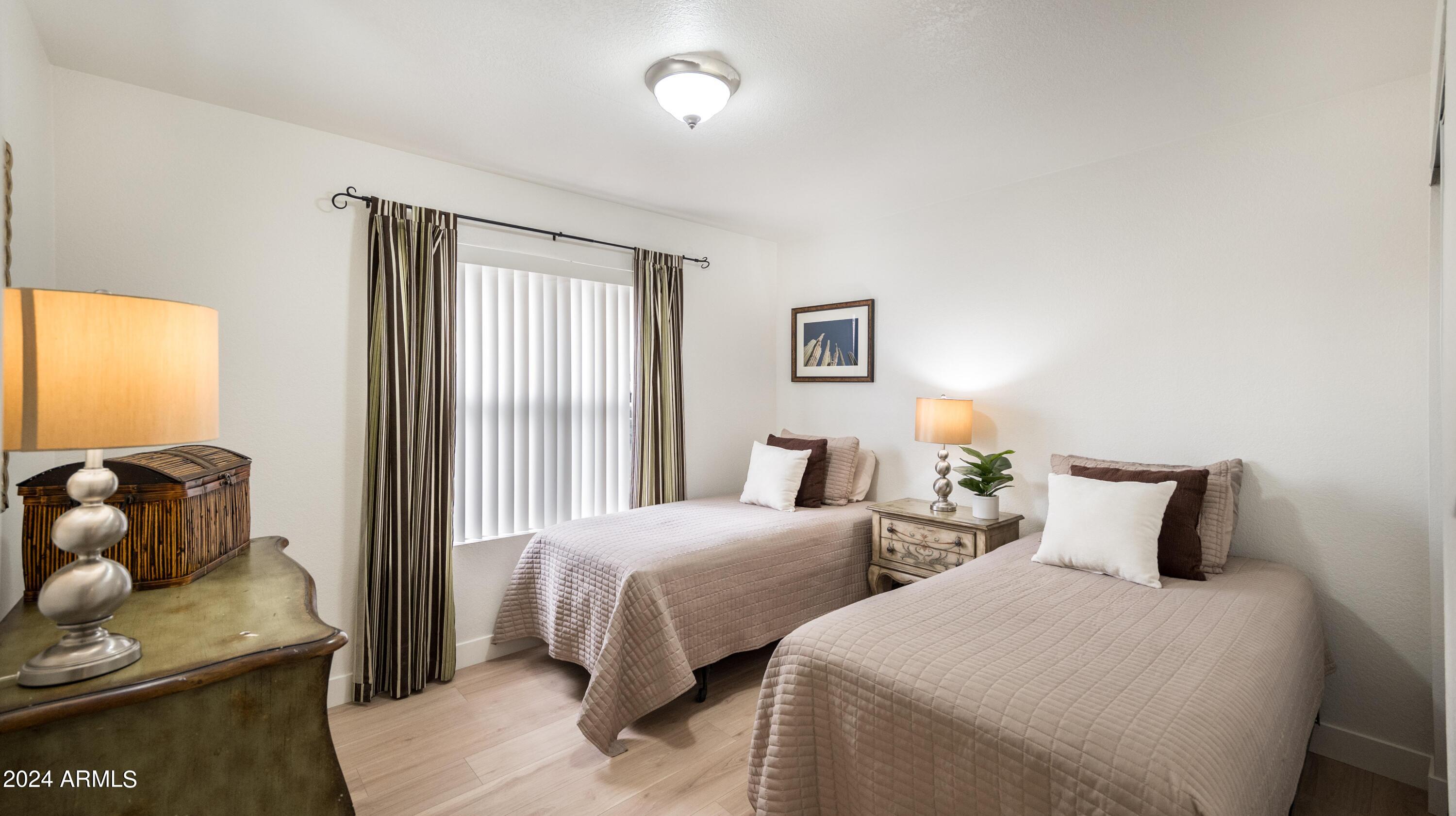 8787 East Mountain View Road, Unit 1034 Scottsdale, AZ 85258 - Photo 25 of 43 a bedroom with two beds and a couch