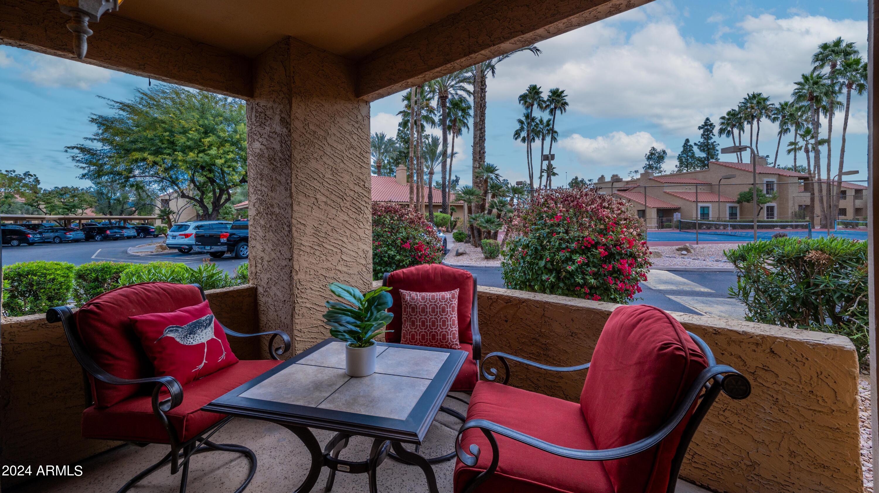 8787 East Mountain View Road, Unit 1034 Scottsdale, AZ 85258 - Photo 27 of 43 a view of a chairs and table in patio with a fire pit